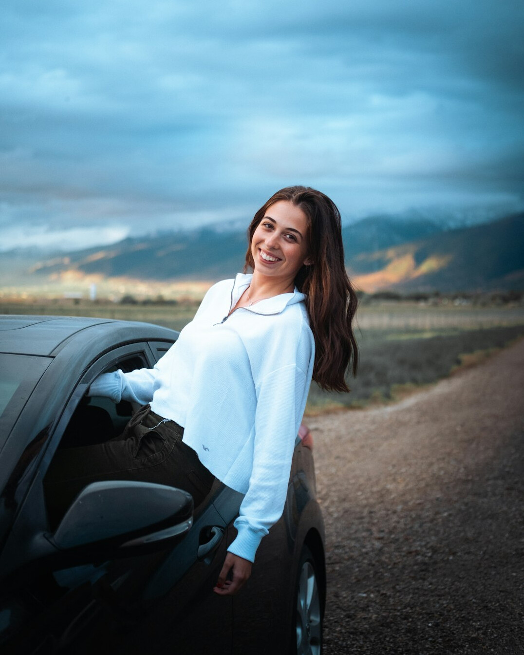 Smiling female driving instructor in a business casual outfit